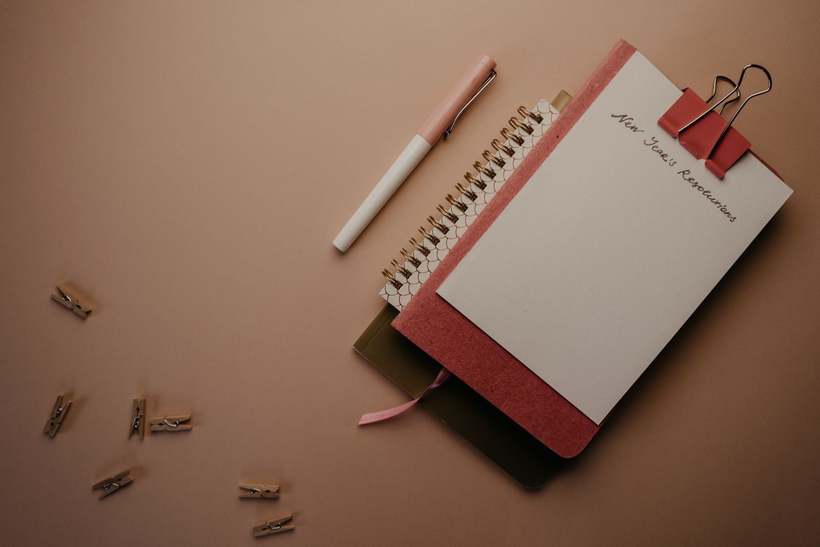 Notebook and planner beside a pen