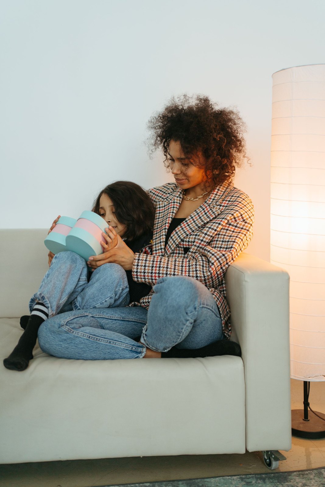 A mother talking to her daughter while sitting on the couch