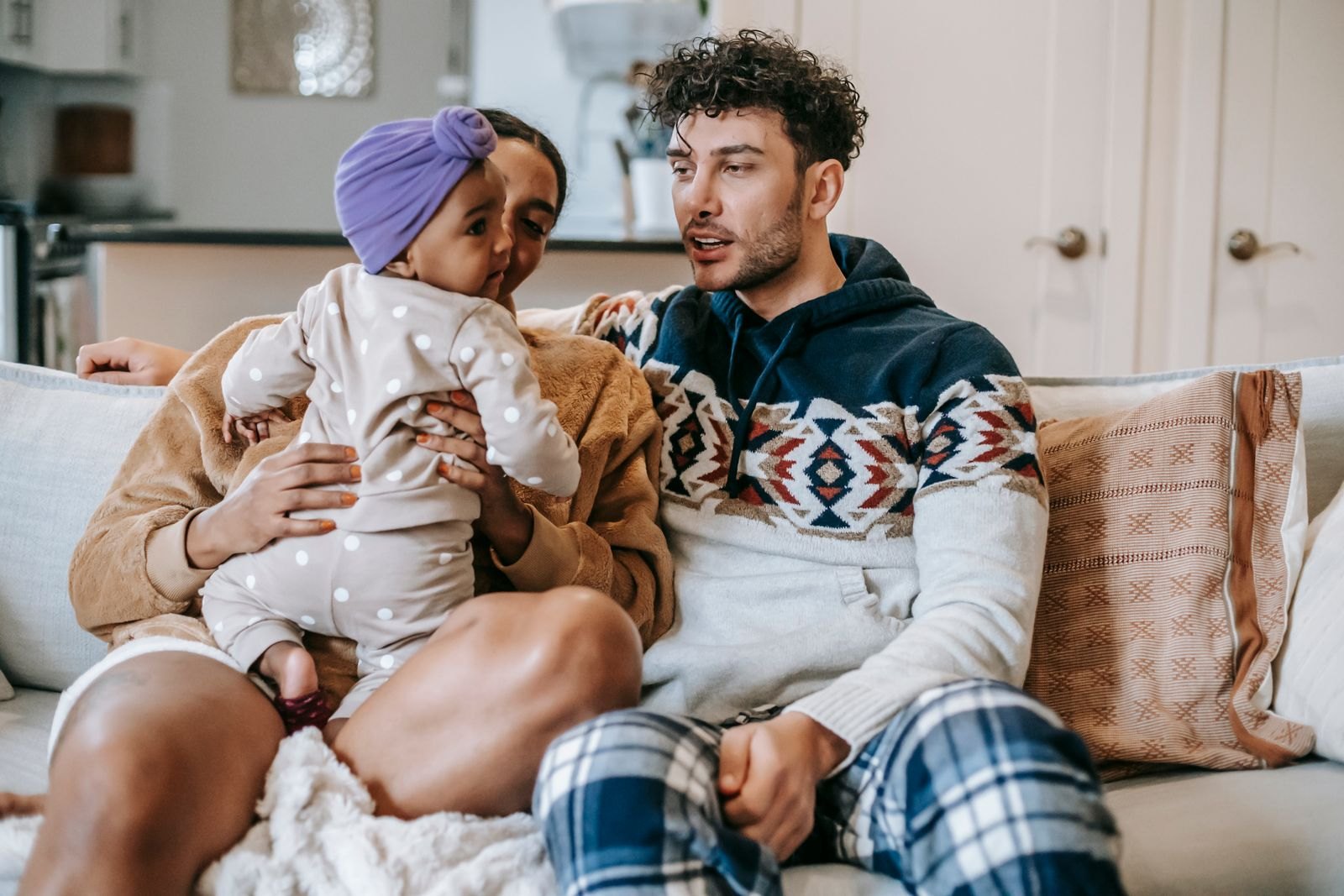 Parents talking with their child on a sofa