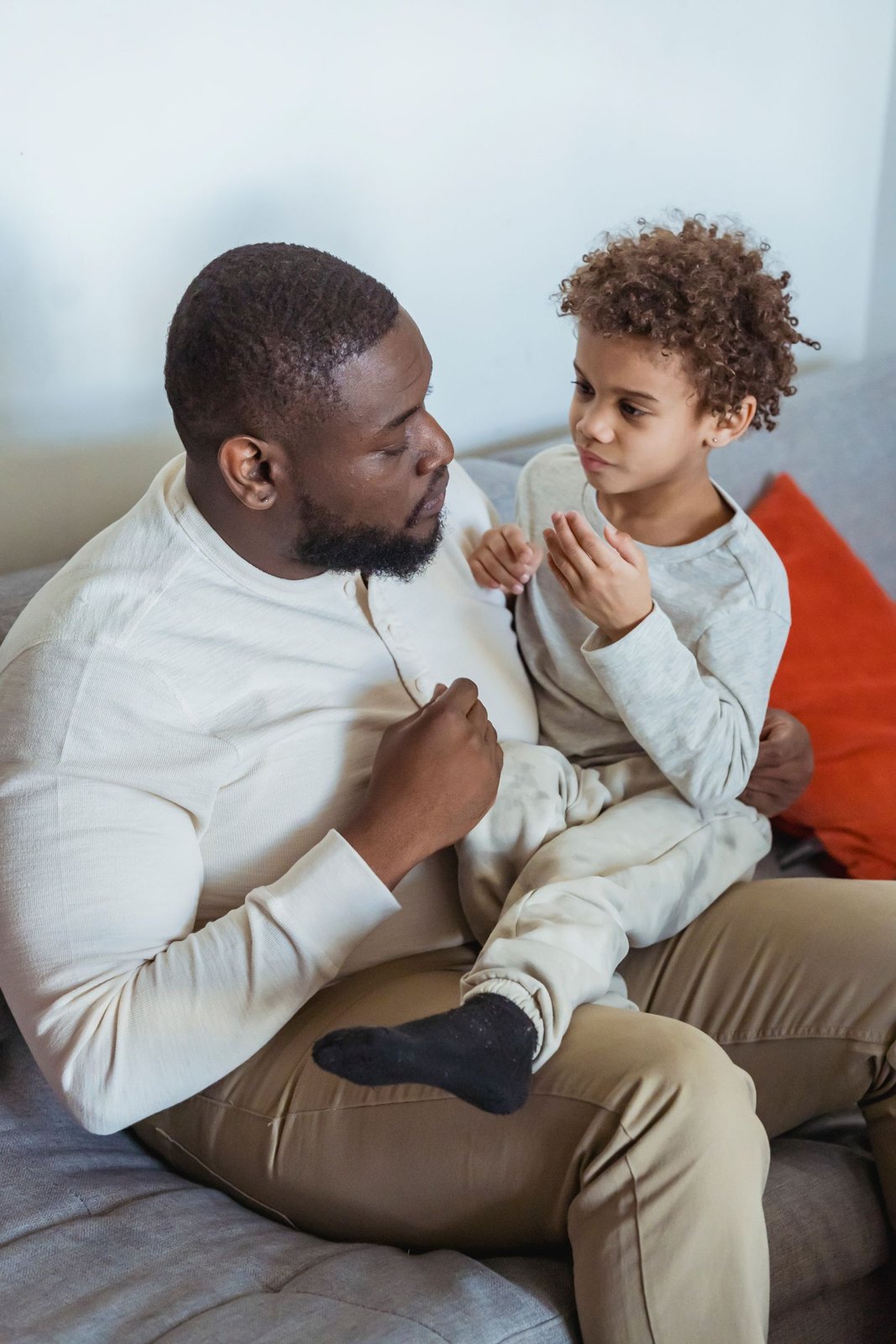 Father talking with his child on his lap