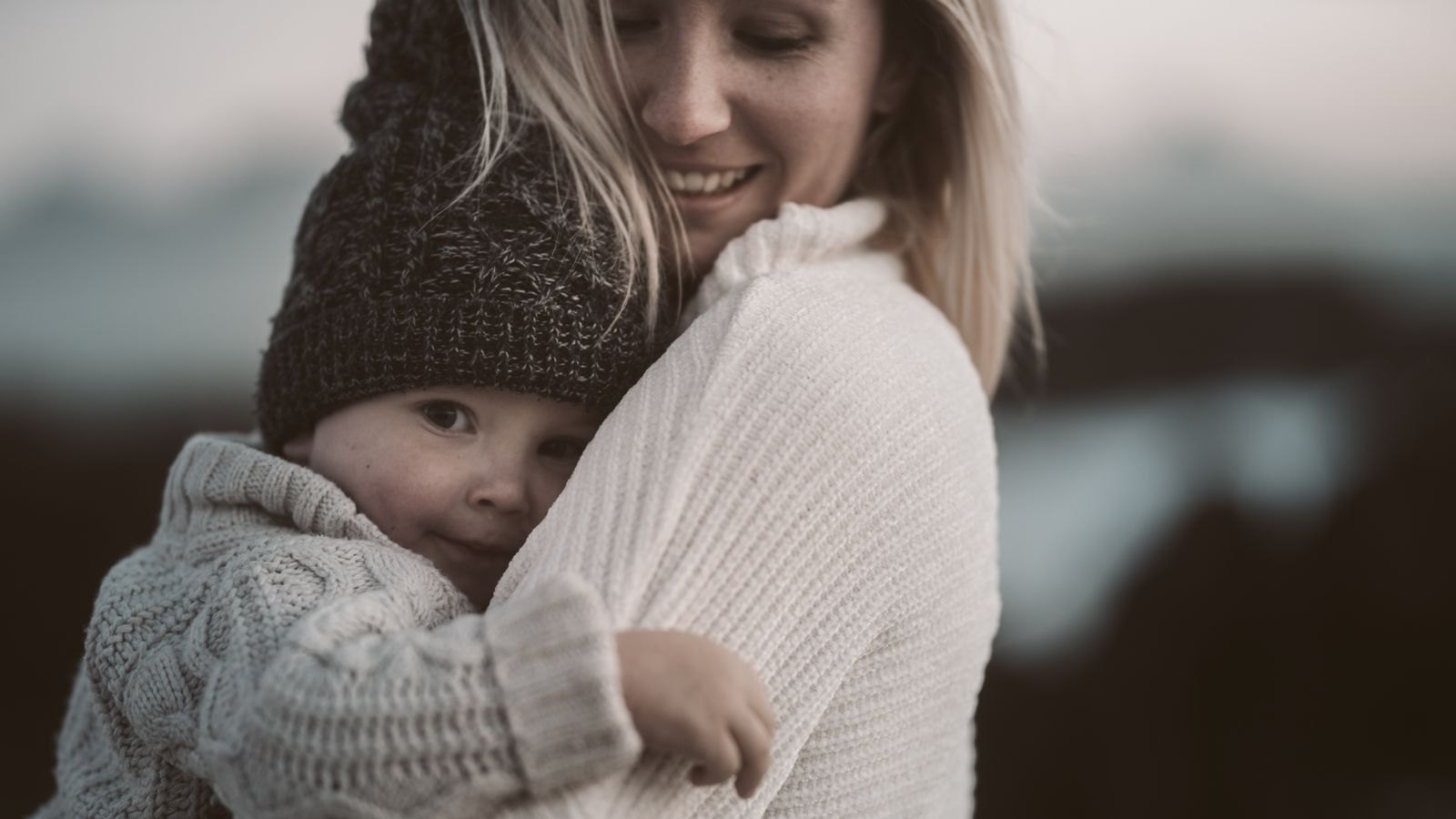 Photo of woman carrying toddler