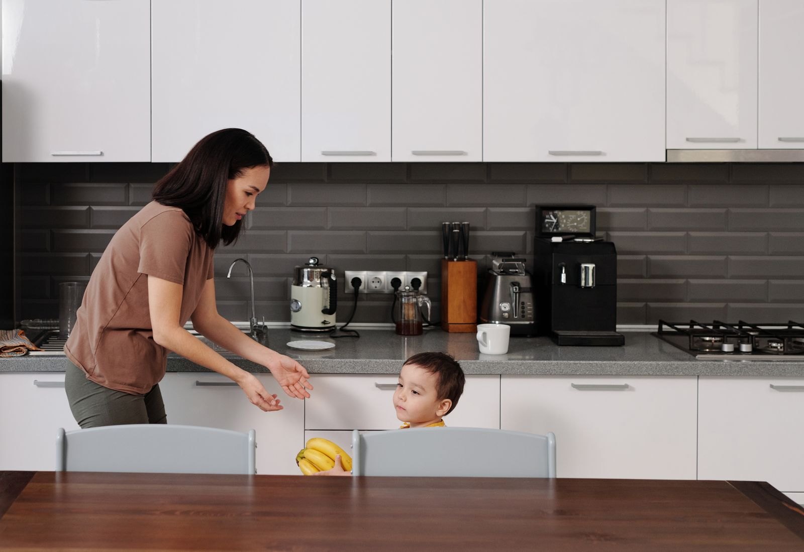 Mother and child talking in the kitchen