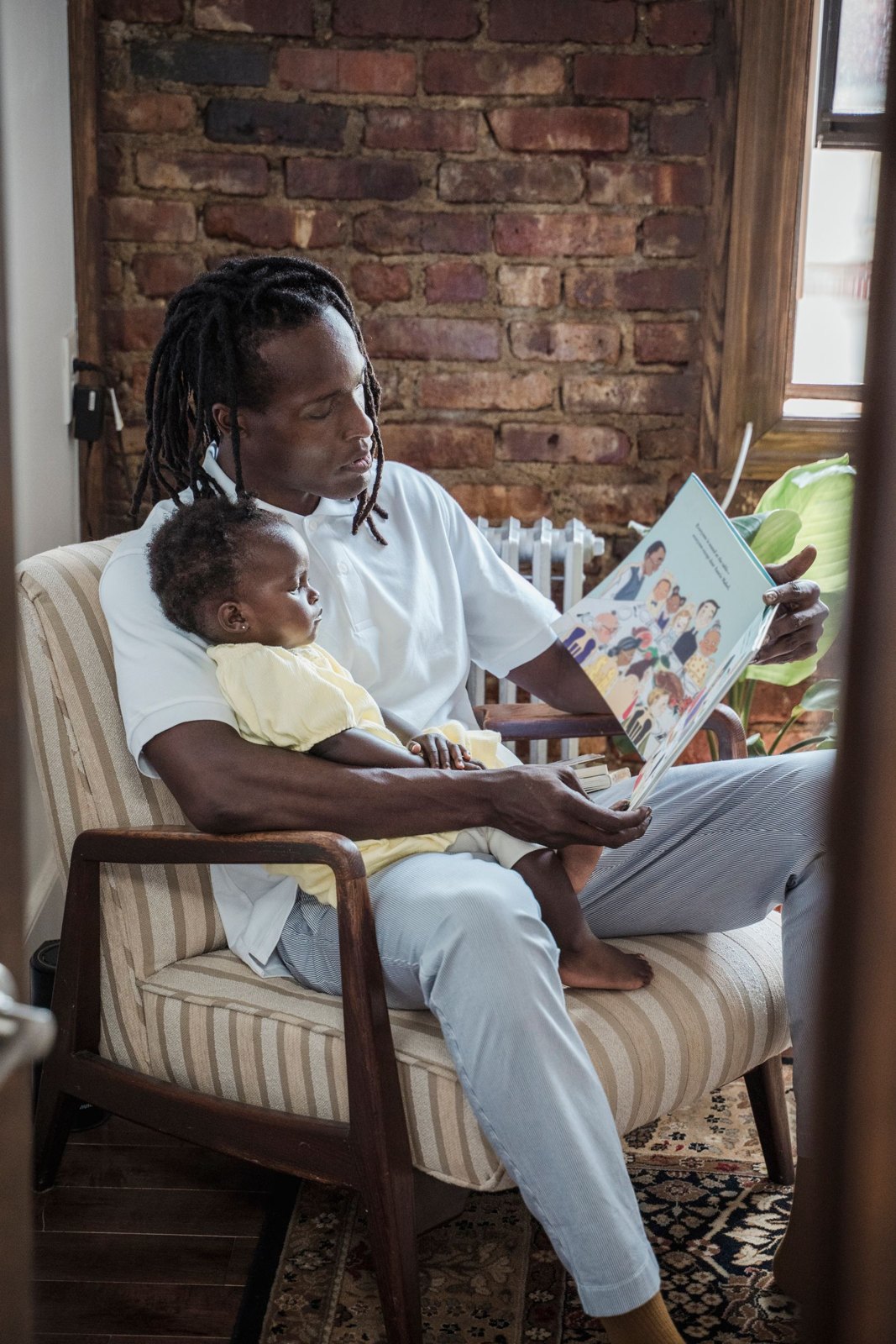 A father reading a book to his child