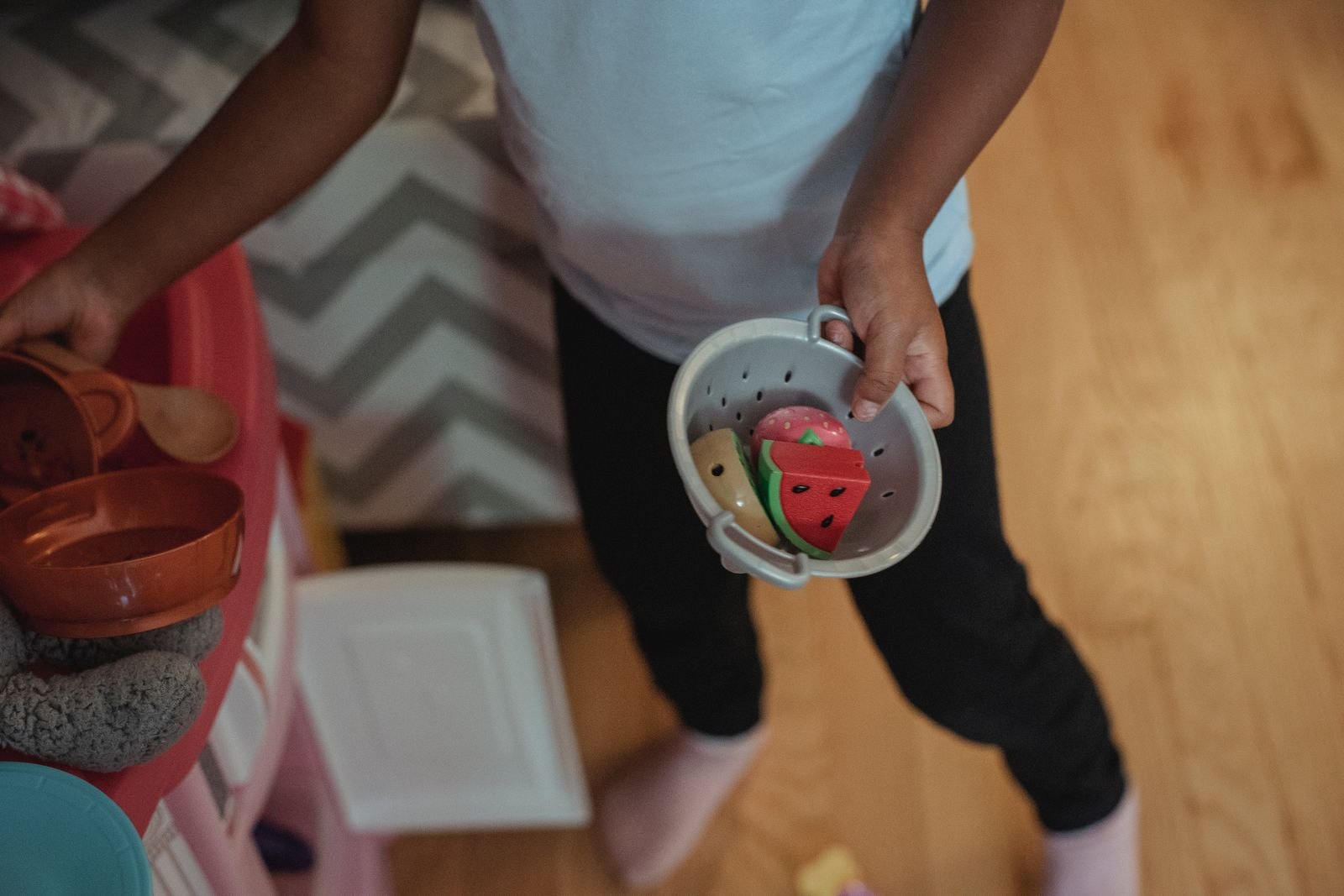 Child playing with toy dishes