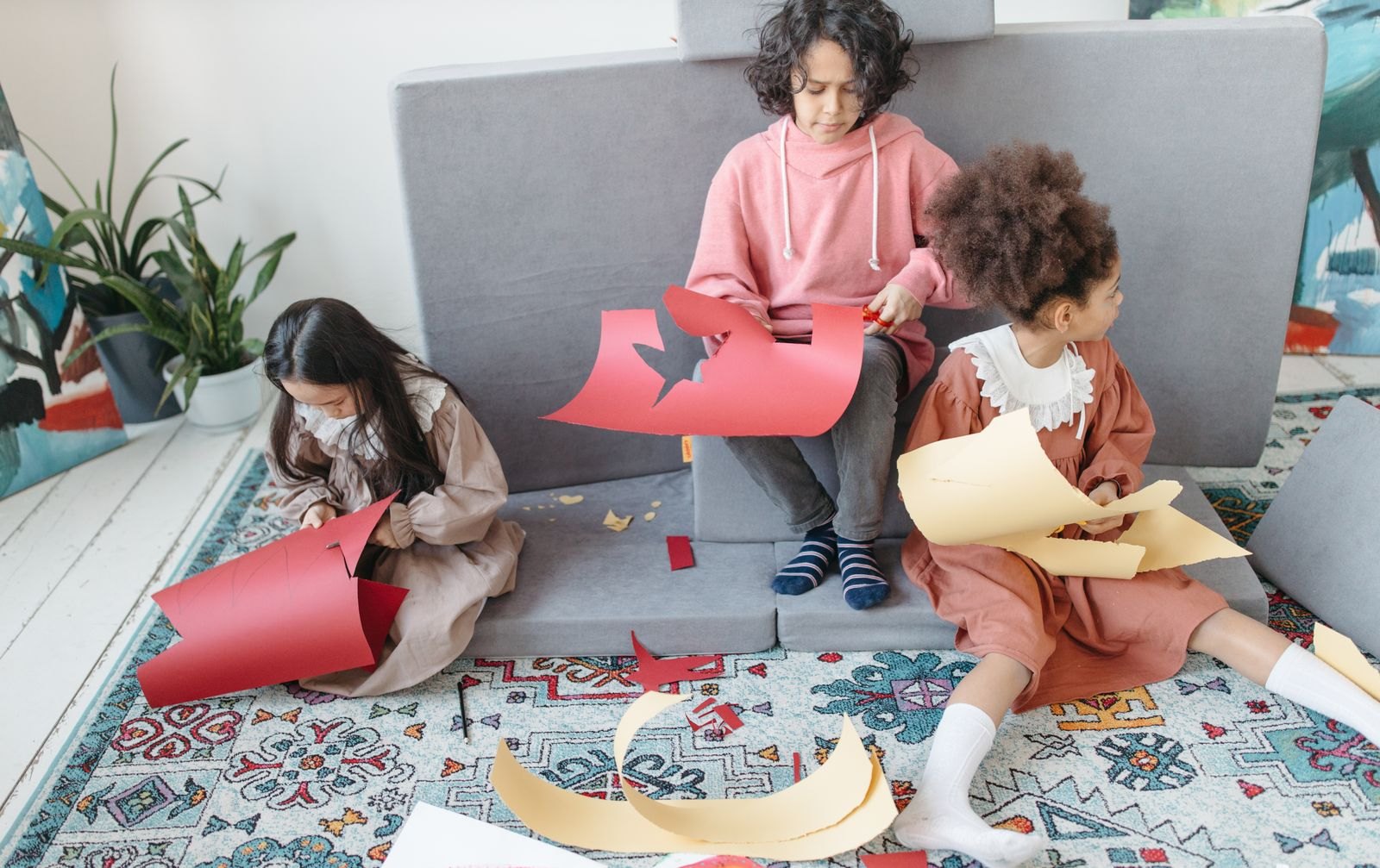 A group of children cutting cardboard papers