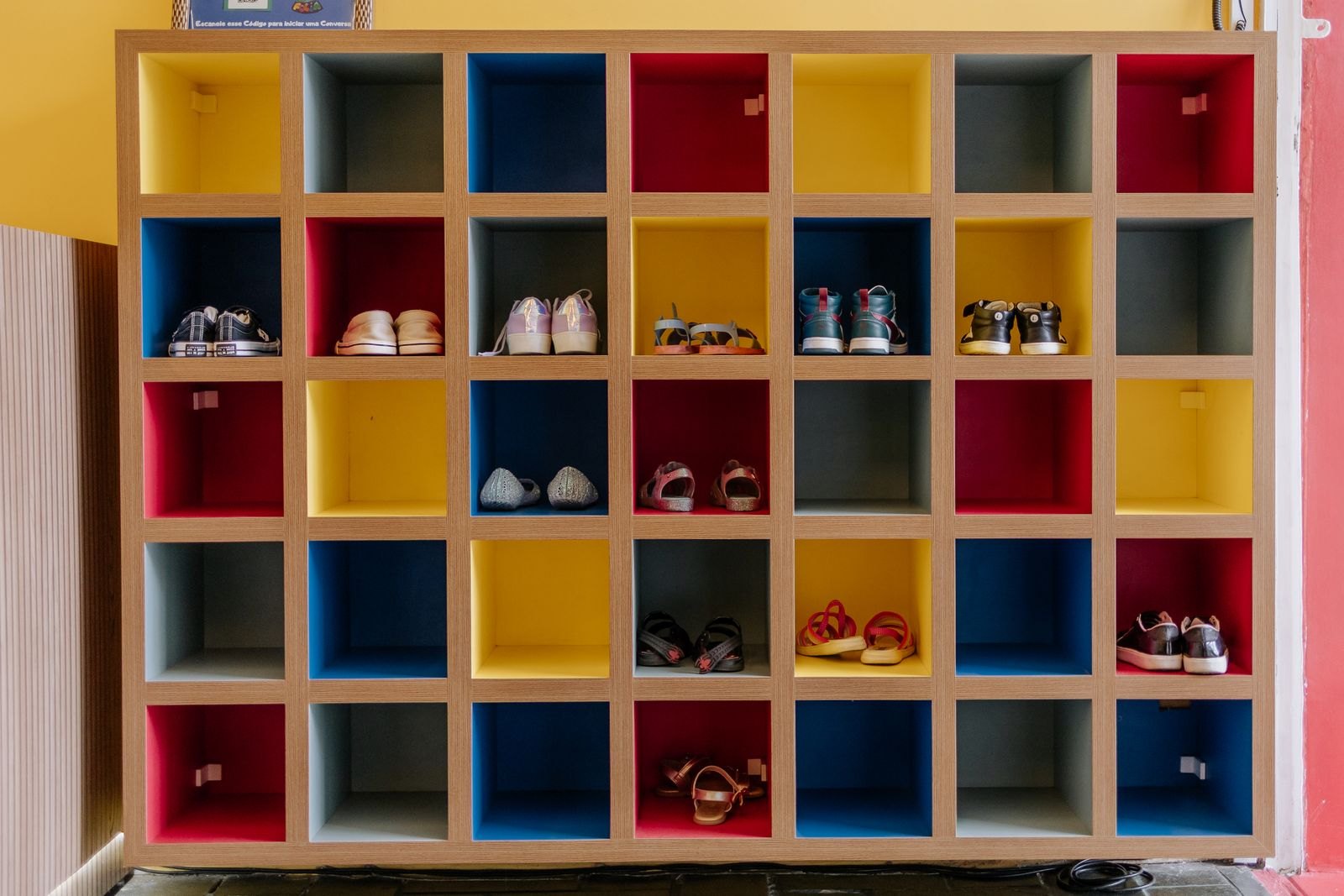 Colorful shoe storage shelf with various shoes