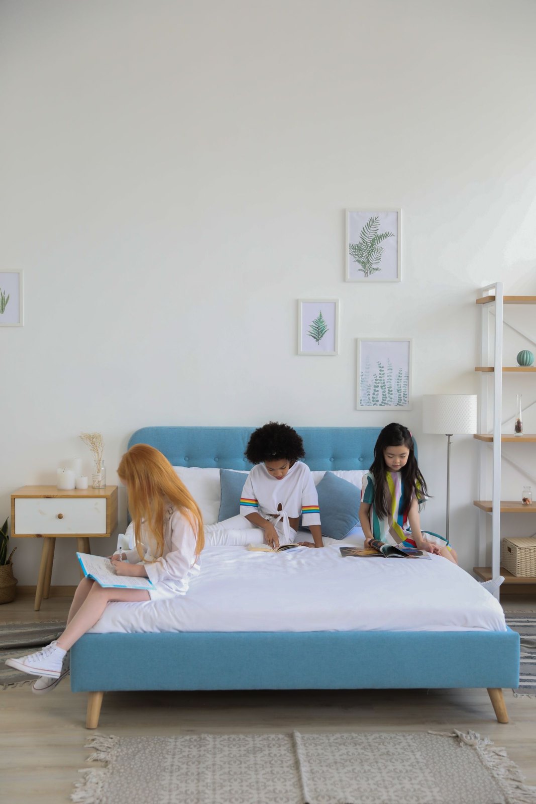 Diverse group of children reading on bed