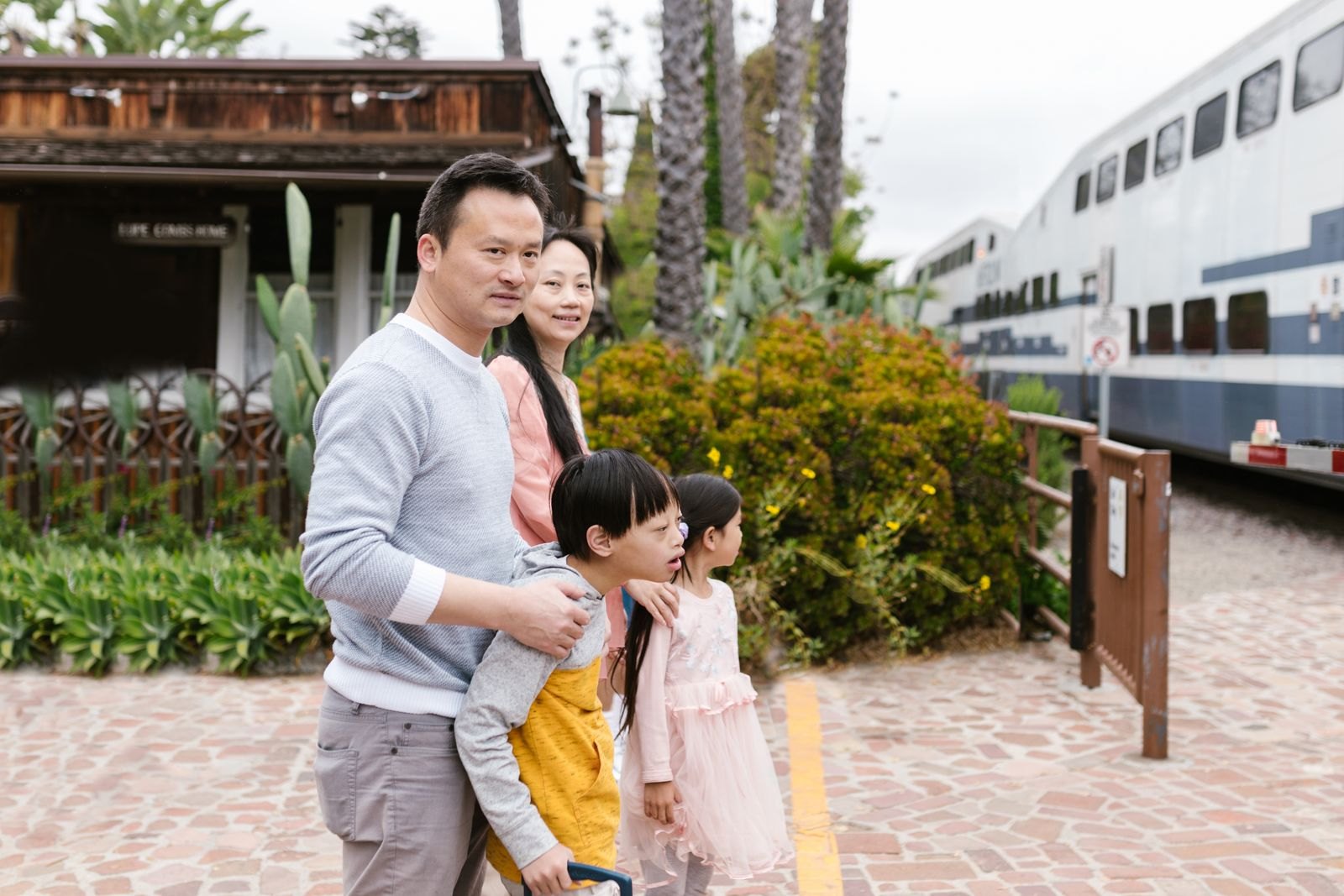 Family waiting together on a train station platform
